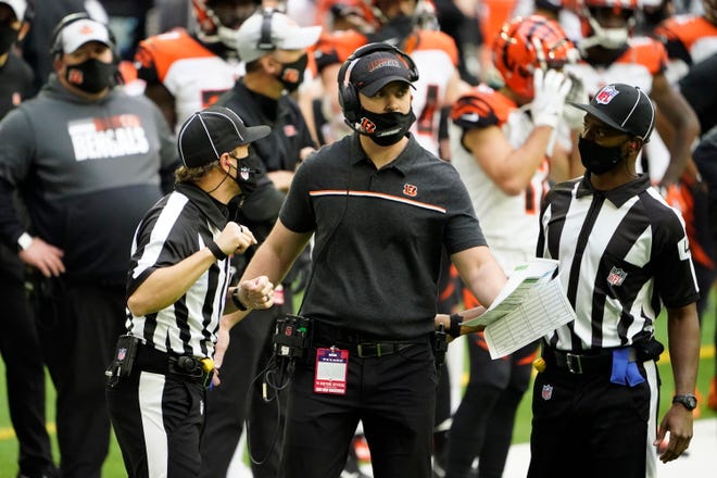 Cincinnati Bengals Zac Taylor talks with officials during the second half of an NFL football game against the Houston Texans Sunday, Dec. 27, 2020, in Houston.