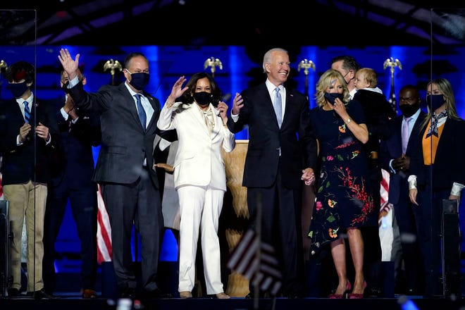 From left, Doug Emhoff, husband of Vice President-elect Kamala Harris, President-elect Joe Biden and Jill Biden celebrate Nov. 7 in Wilmington, Del.
