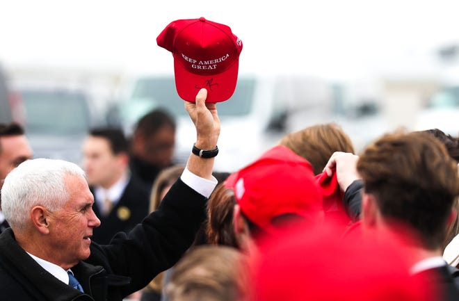 Vice President Mike Pence signs supporters Make America Great Again hats on Wednesday, Nov. 20, 2019, at Austin Straubel International Airport in Green Bay, Wis.
