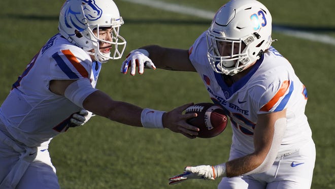 Boise State quarterback Hank Bachmeier (19) hands off the ball to running back Tyler Crowe (33) during the first half of an NCAA college football game San Jose State for the Mountain West championship, Saturday, Dec. 19, 2020, in Las Vegas. (AP Photo/John Locher)