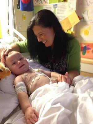 Tanya Gill smiles at Christian in their room at Children's.