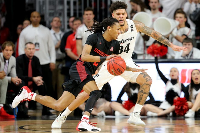 Houston Cougars guard Caleb Mills (2) drives to the basket as Cincinnati Bearcats guard Jarron Cumberland (34) defends in the second half during a college basketball game, Saturday, Feb. 1, 2020, at Fifth Third Arena in Cincinnati. Cincinnati Bearcats won 64-62.