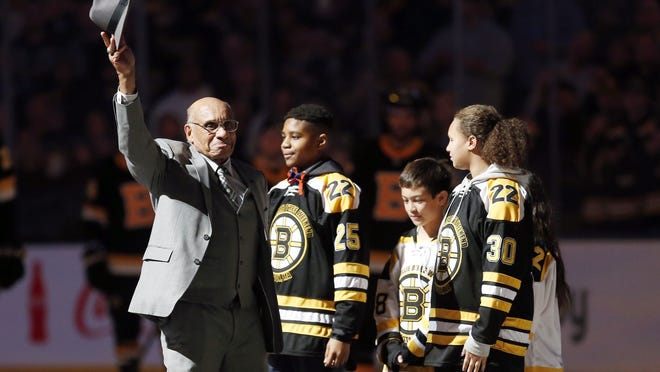 Hockey Hall of Famer Willie O'Ree, right, waves to the crowd before dropping the ceremonial puck before an NHL hockey game between the Boston Bruins and the Edmonton Oilers in Boston, Saturday, Jan. 4, 2020. (AP Photo/Michael Dwyer)