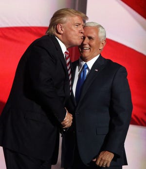 Donald Trump congratulates vice presidential candidate Mike Pence at the 2016 Republican National Convention.