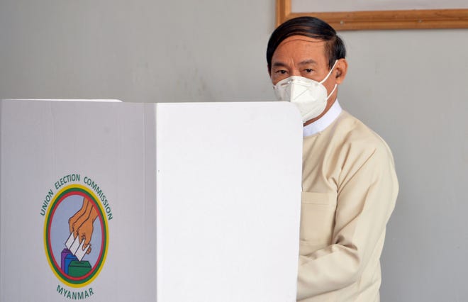 In this file photo taken on October 29, 2020 Myanmar's President Win Myint casts an advance vote at a polling station in Naypyidaw. Myanmar's military has detained the country's de facto leader Aung San Suu Kyi and the country's President Win Myint in an apparent coup, a spokesman for her ruling party said February 1, 2021.