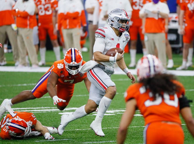 Ohio State quarterback Justin Fields runs past Clemson  defensive end Justin Mascoll (7) during the 2021 Sugar Bowl in the Mercedes-Benz Superdome.
