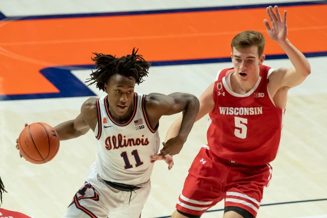 Guard Ayo Dosunmu (11), driving against Wisconsin forward Tyler Wahl (5), recorded the first triple-double by a Fighting Illini player since 2001.
