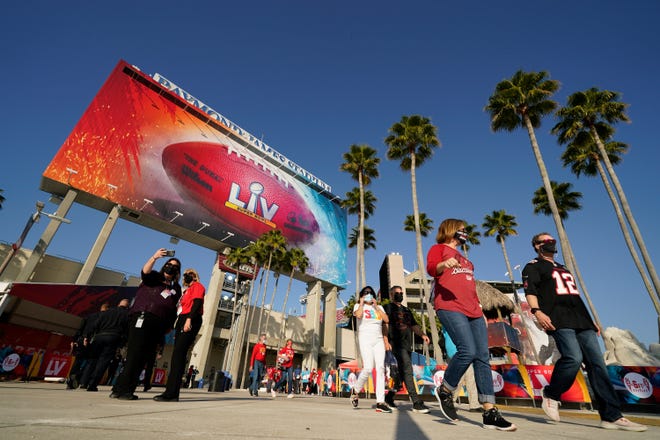 Fans arrive before the NFL Super Bowl 55 football game between the Kansas City Chiefs and Tampa Bay Buccaneers.