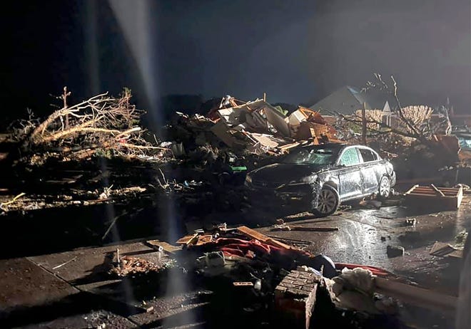 A damaged vehicle is seen among debris after a deadly tornado tore through Brunswick County, N.C., Feb. 16, 2021.  North Carolina authorities say multiple people are dead and others were injured after a tornado ripped through Brunswick County, leaving a trail of heavy destruction.