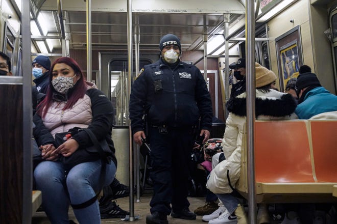 Police patrol the A line subway train bound to Inwood, after NYPD deployed an additional 500 officers into the subway system following deadly attacks, Saturday Feb. 13, 2021, in New York.