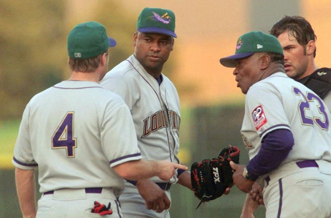 Louisville RiverBats pitcher Jose Rijo, second from left, talks with pitching coach Grant Jackson (23), shortstop Chris Sexton (4), and catcher Corky Miller during the third inning with the bases loaded against the Charlotte Knights on Saturday, July 14, 2001, in Fort Mill, S.C. Rijo, making his third start with the RiverBats, ptiched four innings, walked four, struck out two and gave up two earned runs on five hits.
