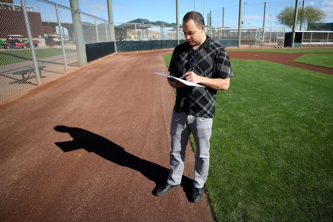 Cincinnati Enquirer Reds beat writer Bobby Nightengale takes notes as pitchers and catchers work out, Saturday, Feb. 16, 2019, at the Cincinnati Reds spring training facility in Goodyear, Arizona.