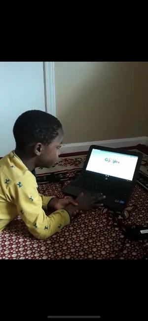 Jean Pierre, a first grade student at Minors Lane Elementary in Louisville, Kentucky, uses a Chromebook provided by Jefferson County Public Schools. Pierre was born in Tanzania and is learning English.
