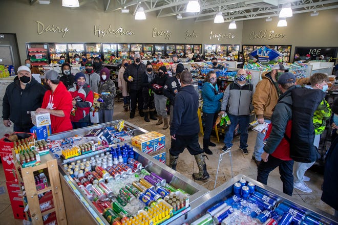 People wait in line to purchase food and snacks at a gas station in Pflugerville, Texas, on Tuesday, Feb 16, 2021. Most homes in the area were without power for nearly eight hours.