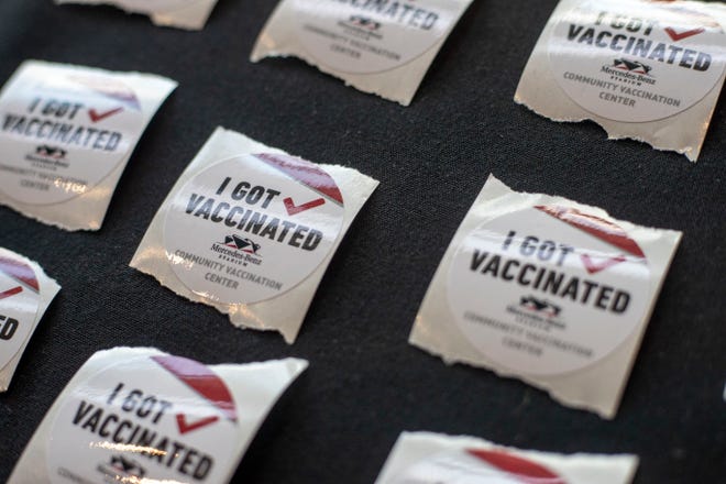 Stickers are available for individuals that receive a COVID-19 vaccination at the Mercedes-Benz Stadium Community Vaccination Center in Atlanta on March 30.