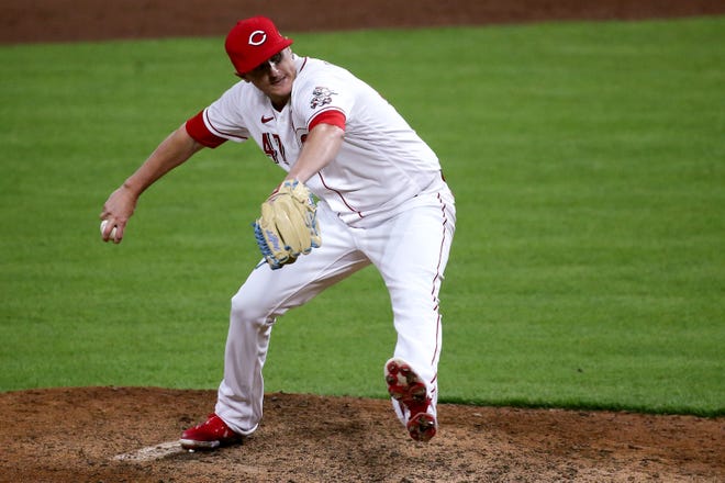 Cincinnati Reds relief pitcher Brad Brach (47) delivers in the ninth inning during a baseball game against the Milwaukee Brewers, Friday, May 21, 2021, at Great American Ball Park in Cincinnati. The Cincinnati Reds won, 9-4. 