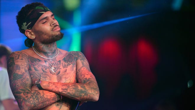 Chris Brown is being accused of hitting a woman at a Los Angeles residence, reports say.