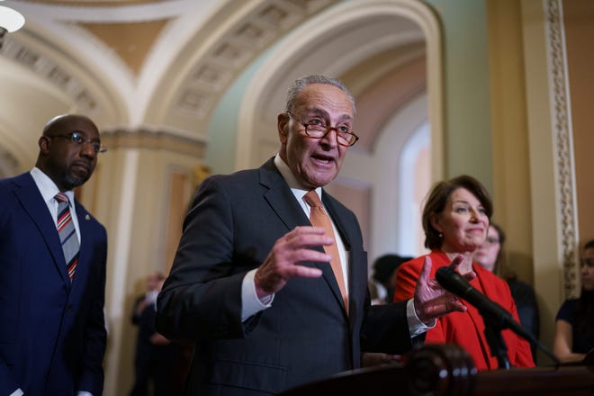 Senate Majority Leader Chuck Schumer, D-N.Y., flanked by Sen. Raphael Warnock, D-Ga., left, and Sen. Amy Klobuchar, D-Minn., speaks with reporters before a key test vote on the For the People Act.