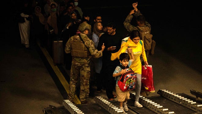 Afghans civilians are evacuated by the US military on Aug. 19, 2021 at an undisclosed location. US evacuation operations from Kabul's airport slowed Friday because the receiving base in Qatar was overflowing and could not receive evacuees.
