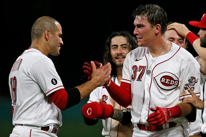 Cincinnati Reds catcher Tyler Stephenson (37) is mobbed by teammates after hitting the game-winning RBI single in the ninth inning of the MLB National League game between the Cincinnati Reds and the San Diego Padres at Great American Ball Park in downtown Cincinnati on Thursday, July 1, 2021. The Reds won 5-4 on a walk-off single, with the bases loaded, off the bat of Tyler Stephenson. 