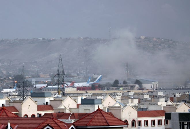 Smoke rises from an explosion outside the airport in Kabul, Afghanistan, on Aug. 26, 2021.