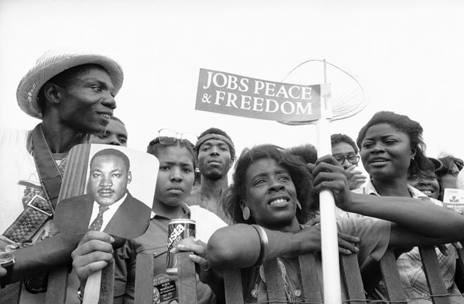 Evelyn Copeland holds a sign during the rally at the Lincoln Memorial in Washington, D.C., on Aug. 27, 1983, capping the "Peace, Jobs and Freedom” march, which commemorated the 1963 civil rights demonstration led by Martin Luther King Jr. The Wilmington, Del., resident was among the participants in the original march.