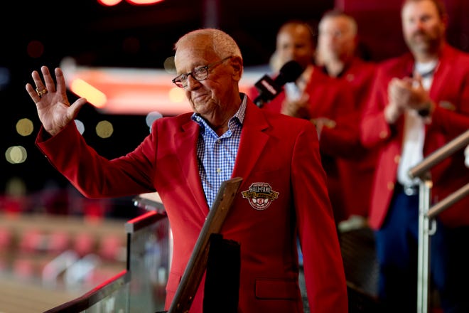 Marty Brennaman waives after receiving his Reds Hall of Fame jacket during the 2021 Reds Hall of Fame induction ceremony for Marty Brennaman on Friday, Aug. 27, 2021, at Great American Ball Park in Cincinnati. 