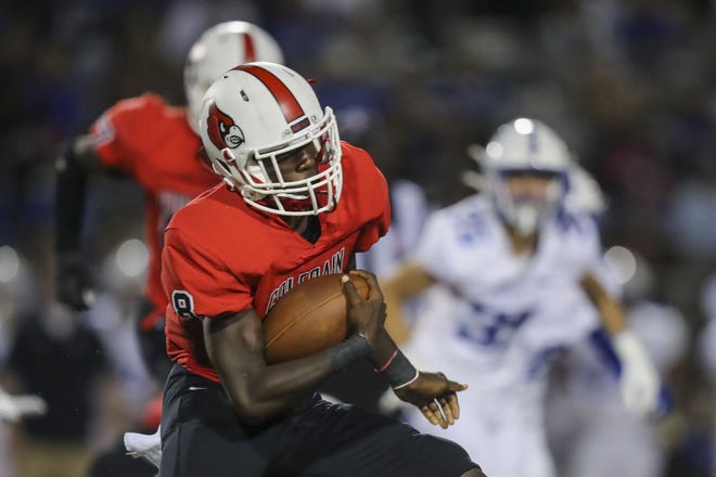 Colerain quarterback Zaccaeus Jennings (8) runs with the ball against St. Xavier in the second half at Colerain High School Aug. 27, 2021.