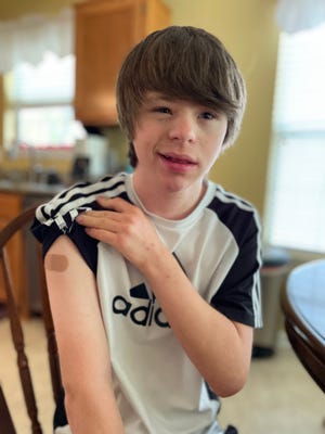 Kim Hart's 18-year-old son, who has Down syndrome, after getting his first dose of the Moderna vaccine