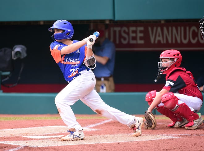 Michigan third baseman Jackson Surma hits a two-run double in the first inning against Ohio during the Little League World Series championship game.