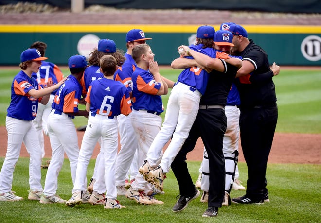 Michigan players and coaches celebrate after beating Ohio 5-2 to win the 2021 Little League World Series championship.