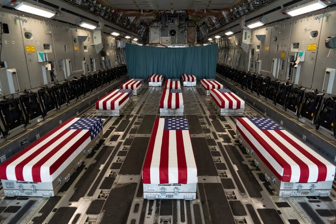 In this image provided by the U.S. Air Force, flag-draped transfer cases line the inside of a transport plane on Sunday prior to a dignified transfer at Dover Air Force Base in Delaware. The fallen service members were killed while supporting non-combat operations in Kabul, Afghanistan.