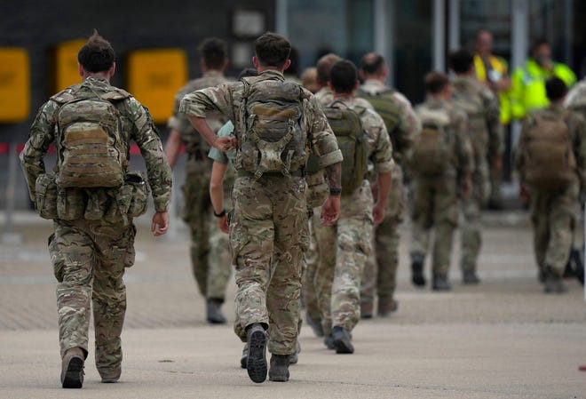 Members of the British armed forces 16 Air Assault Brigade walk to the air terminal after disembarking a Royal Airforce Voyager aircraft at Brize Norton, Oxfordshire on August 28, 2021, as the troops return from assisting with the evacuation of people from Kabul airport in Afghanistan. - The UK is winding up its operation to airlift civilians ahead of the August 31 deadline for US troop withdrawal as Taliban forces prepare to take over the airport. (Photo by Alastair Grant / POOL / AFP) (Photo by ALASTAIR GRANT/POOL/AFP via Getty Images) ORG XMIT: 0 ORIG FILE ID: AFP_9LT3DZ.jpg