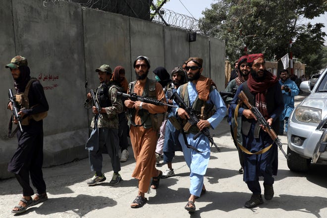 Taliban fighters patrol in Kabul, Afghanistan, on Aug. 18. The Taliban declared an "amnesty" across Afghanistan and urged women to join their government, seeking to convince a wary population that they have changed.