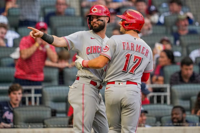 Aug 12, 2021; Cumberland, Georgia, USA; Cincinnati Reds shortstop Kyle Farmer (17) reacts with left fielder Jesse Winker (left) after hitting a two-run home run against the Atlanta Braves during the sixth inning at Truist Park. Mandatory Credit: Dale Zanine-USA TODAY Sports