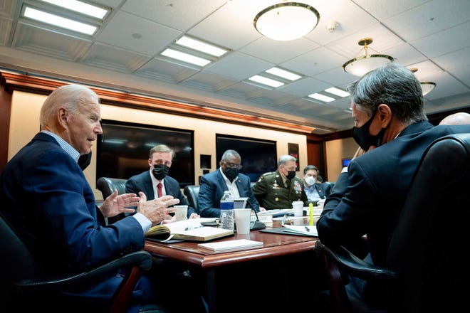 In this image released by The White House, President Joe Biden speaks with his national security team during a briefing on the situation in Afghanistan, Sunday, Aug. 22, 2021, in the White House Situation Room in Washington. (Erin Scott/The White House via AP) ORG XMIT: DCJE101