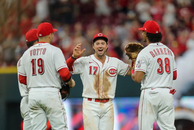Cincinnati Reds shortstop Kyle Farmer (17) reacts with first baseman Joey Votto (19) and second baseman Jose Barrero (38) after the game against the Miami Marlins at Great American Ball Park on Aug. 21.