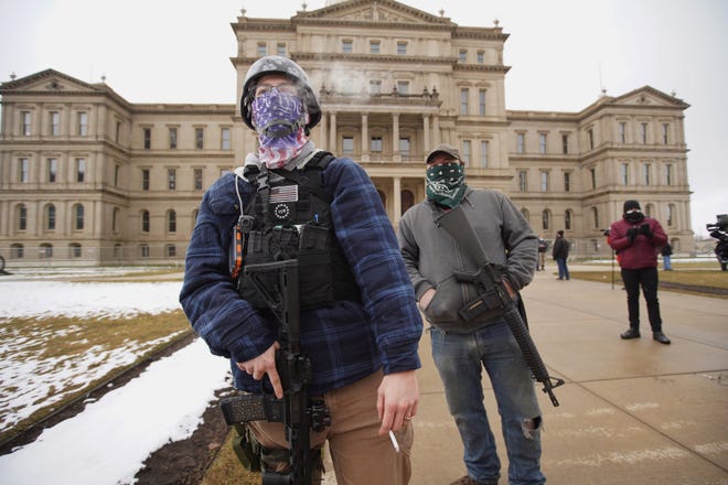 A member of the Boogaloo Bois attends a protest outside of the Michigan State Capitol building in downtown Lansing on Sunday, January 17, 2021.