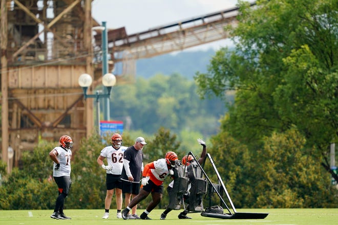 Cincinnati Bengals offensive line coach Frank Pollock leads drills with the unit during training camp practice, Monday, Aug. 16, 2021, at the practice fields next to Paul Brown Stadium in Cincinnati.