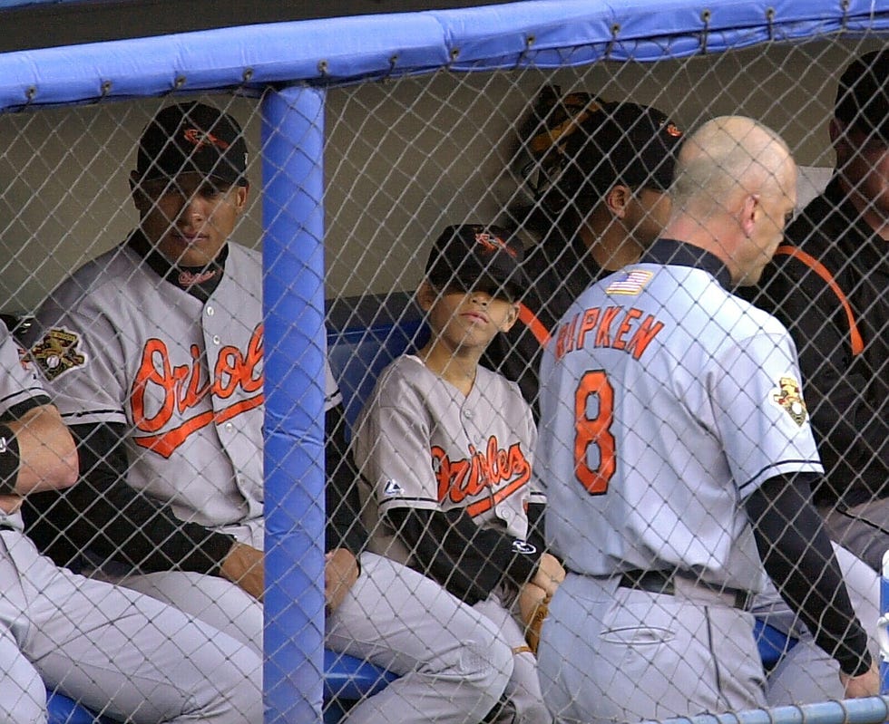 Kevin Villa sits in the Orioles dugout at Yankee Stadium along with Baltimore Orioles infielder David Segui 9/29/2001. Kevin's mother, Yamel Jager Merino, an EMT, was killed in the Sept. 11 attacks on the World Trade Center.
