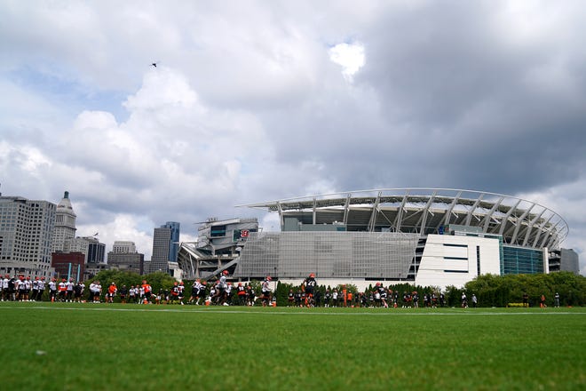 The Cincinnati Bengals first-team offense runs a play during training camp practice, Monday, Aug. 16, 2021, at the practice fields next to Paul Brown Stadium in Cincinnati.