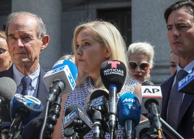Virginia Giuffre, center, who says she was trafficked by sex offender Jeffrey Epstein, sued Prince Andrew saying he sexually assaulted her when she was 17.