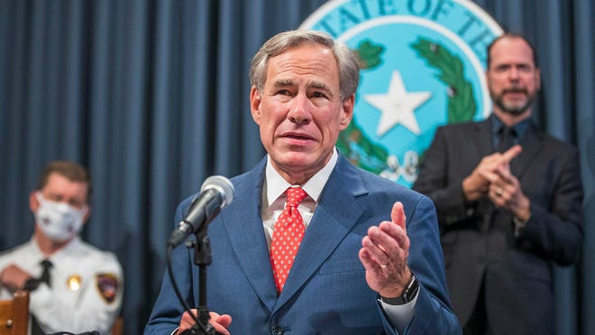 Texas Gov. Greg Abbott , shown at a Sept. 9, 2021, press conference, says President Biden's immigration policies are motivating him to build around 733 miles of border wall to keep out undocumented crossers.