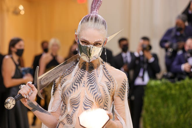 Grimes took the phrase "slaying the red carpet" to the next level by bringing a sword to the Met Gala.