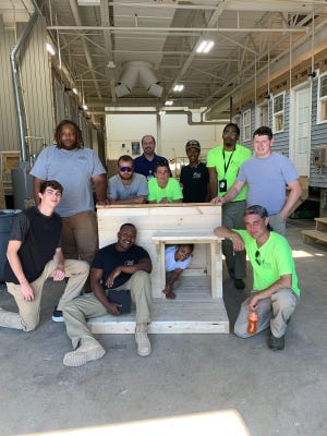 Adult and high school construction students from Great Oaks Career Campuses in Sharonville with one of the luxury dog houses being built for Homearama 2021