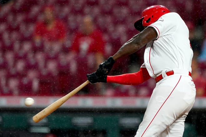 Cincinnati Reds left fielder Aristides Aquino (44) hits a home run in the fifth inning of a baseball game against the Chicago Cubs, Monday, Aug. 16, 2021, at Great American Ball Park in Cincinnati. 
