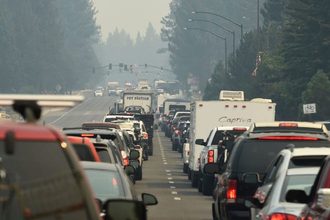 Evacuation traffic backs up in South Lake Tahoe, Calif., as mandatory evacuations are announced because of the Caldor Fire on  Aug. 30. Thousands of people rushed to get out of South Lake Tahoe as the entire tourist resort city came under evacuation orders and wildfire raced toward the large freshwater lake of Lake Tahoe, which straddles California and Nevada.