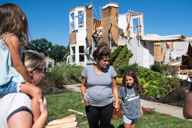 Ashley Thomas, left, with her daughter Kenley Thomas, 6, Thursday, Sept. 2, 2021 after their home was severely damaged by a tornado in Mullica Hill, N.J.