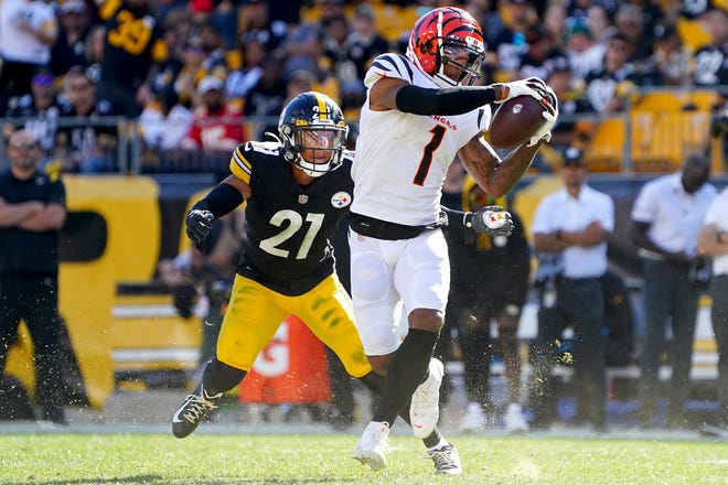 Cincinnati Bengals wide receiver Ja'Marr Chase (1) catches a pass as Pittsburgh Steelers cornerback Tre Norwood (21) defends in the fourth quarter during a Week 3 NFL football game, Sunday, Sept. 26, 2021, at Heinz Field in Pittsburgh.
