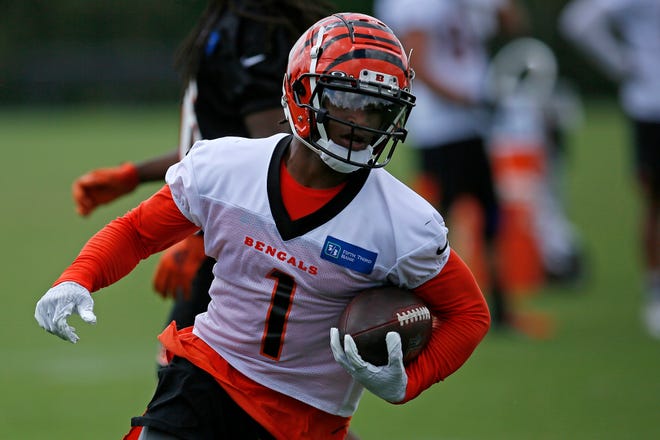 Cincinnati Bengals wide receiver Ja'Marr Chase (1) runs down field after a catch during a training camp practice at the Paul Brown stadium practice facility in downtown Cincinnati on Wednesday, Aug. 18, 2021.